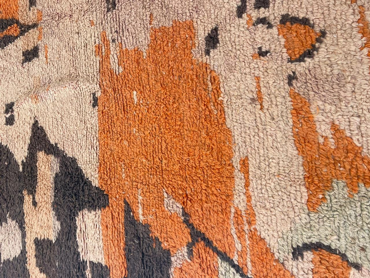 Detail shot of a vintage Moroccan rug highlighting artistic patterns and a woven texture.