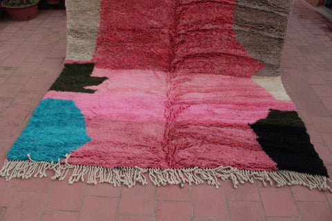 Detail close-up of a pink geometric Moroccan rug showcasing its textured surface.