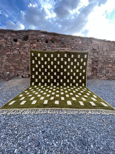 Lifestyle shot of the olive green checkered Moroccan rug featuring a geometric pattern.