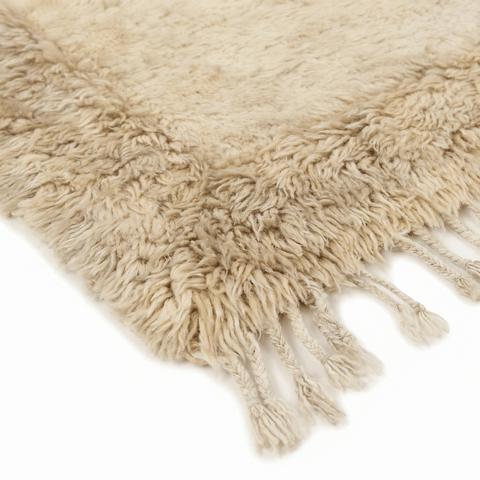 Front view of the cream and taupe handwoven Beni Ourain rug showcasing its shag texture.