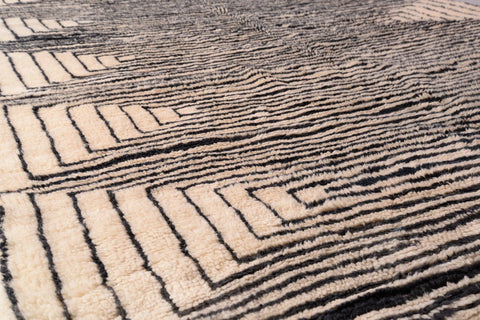 Detail shot of the layered design and textured surface of the black and beige Moroccan Mrirt rug.