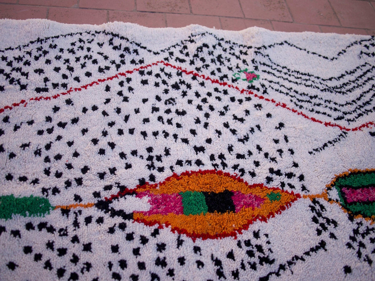 Close-up detail of the colorful geometric pattern on a multicolor Moroccan rug.