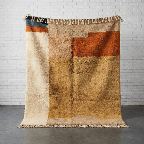 Front view of the modern warm colors Moroccan rug featuring geometric patterns in beige, orange, and brown.