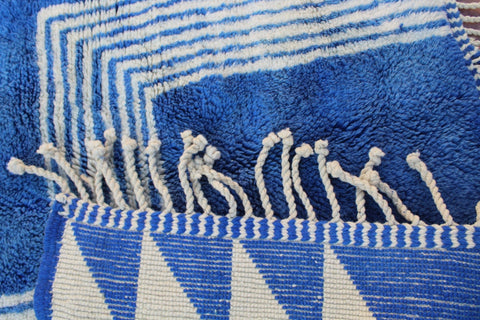 Detail shot of a blue and white rug highlighting its distinctive design.