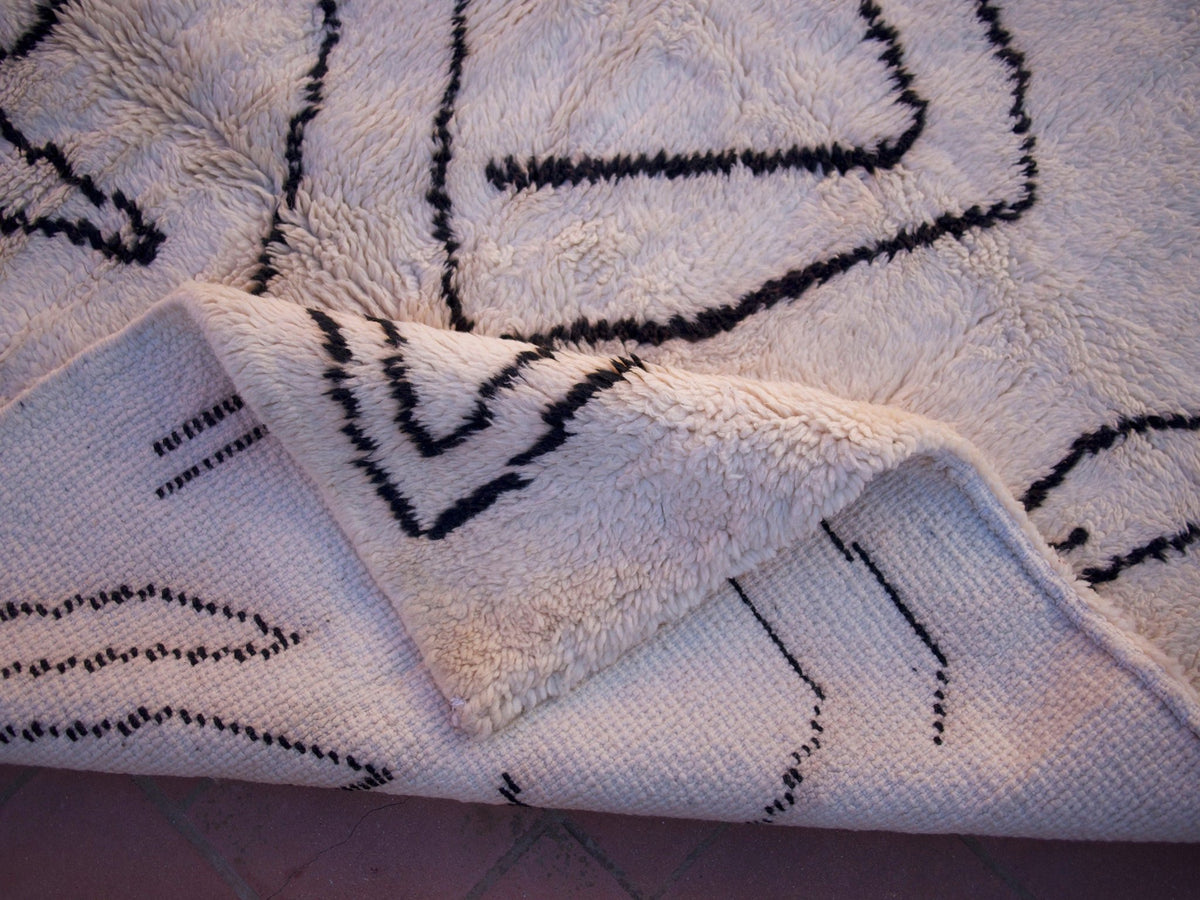 Close-up detail of the fringe edge on the white and black Beni Ourain Moroccan rug.