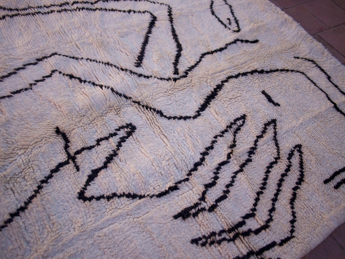 Close-up detail of the textured surface of the white and black Beni Ourain Moroccan rug.
