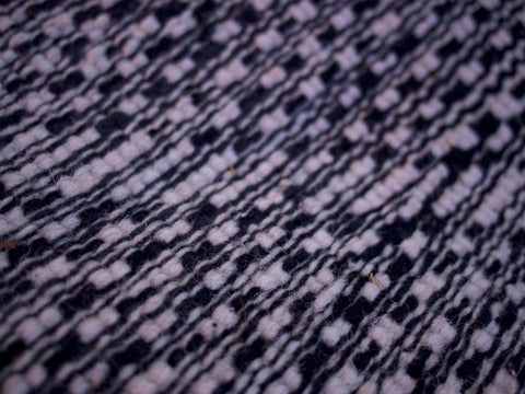 Detail shot of the Moroccan Beni Ourain rug featuring geometric patterns in black and white.