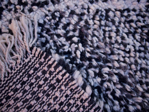 Close-up view of the black and white geometric design on the Beni Ourain rug.