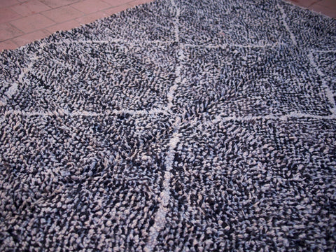 Close-up detail of the black and white geometric design on the Beni Ourain rug.