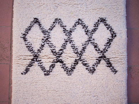 Detail close-up of the black and white Beni Ourain runner rug featuring geometric patterns.