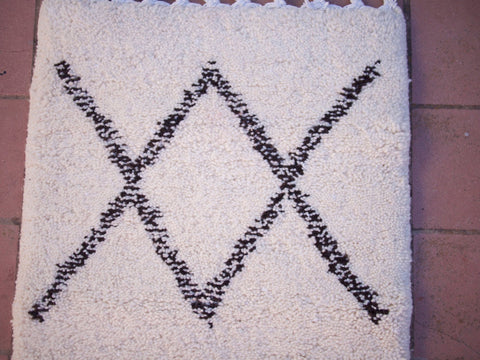 Detail close-up of the black and white Beni Ourain runner rug with a focus on its geometric pattern.