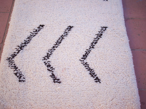 Detail close-up of the black and white Beni Ourain runner rug highlighting its geometric design.