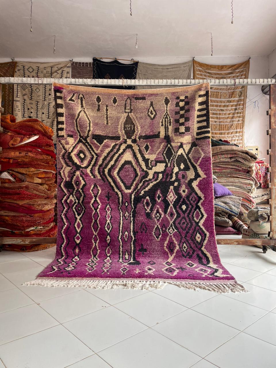Close-up detail of the Moroccan Boujaad rug highlighting fringe edges and textured wool.