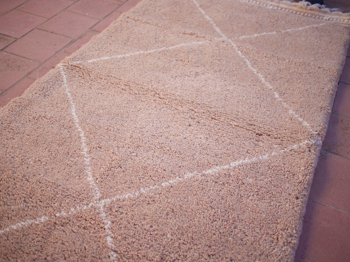Close-up detail of the plain design and texture of the brown Moroccan rug.