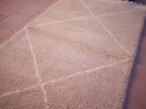 Close-up detail of the plain design and texture of the brown Moroccan rug.