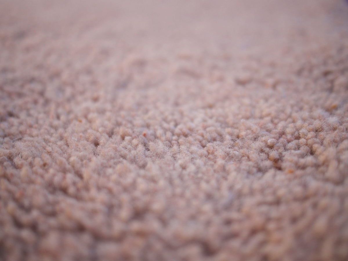 Close-up view highlighting the textured surface of the brown Moroccan rug.