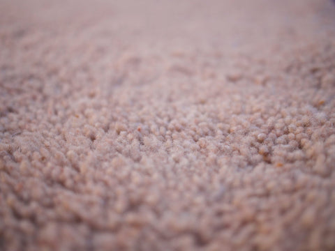 Close-up view highlighting the textured surface of the brown Moroccan rug.