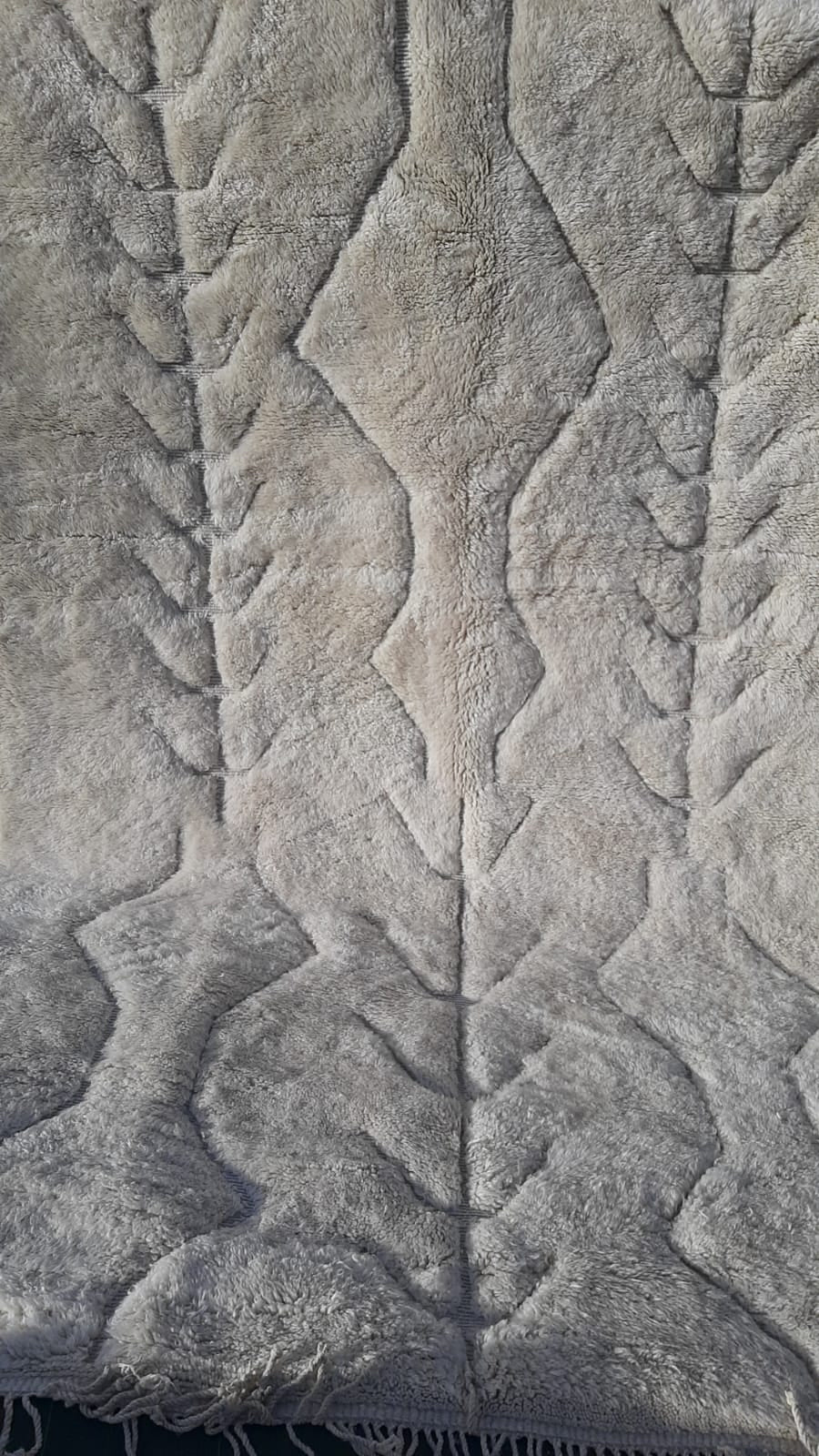 Close-up of the intricate design and soft texture of a Moroccan Mrirt rug.