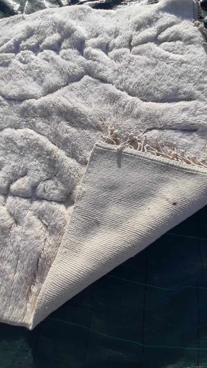 Close-up detail of the textured pattern on a tufted Moroccan Mrirt rug.