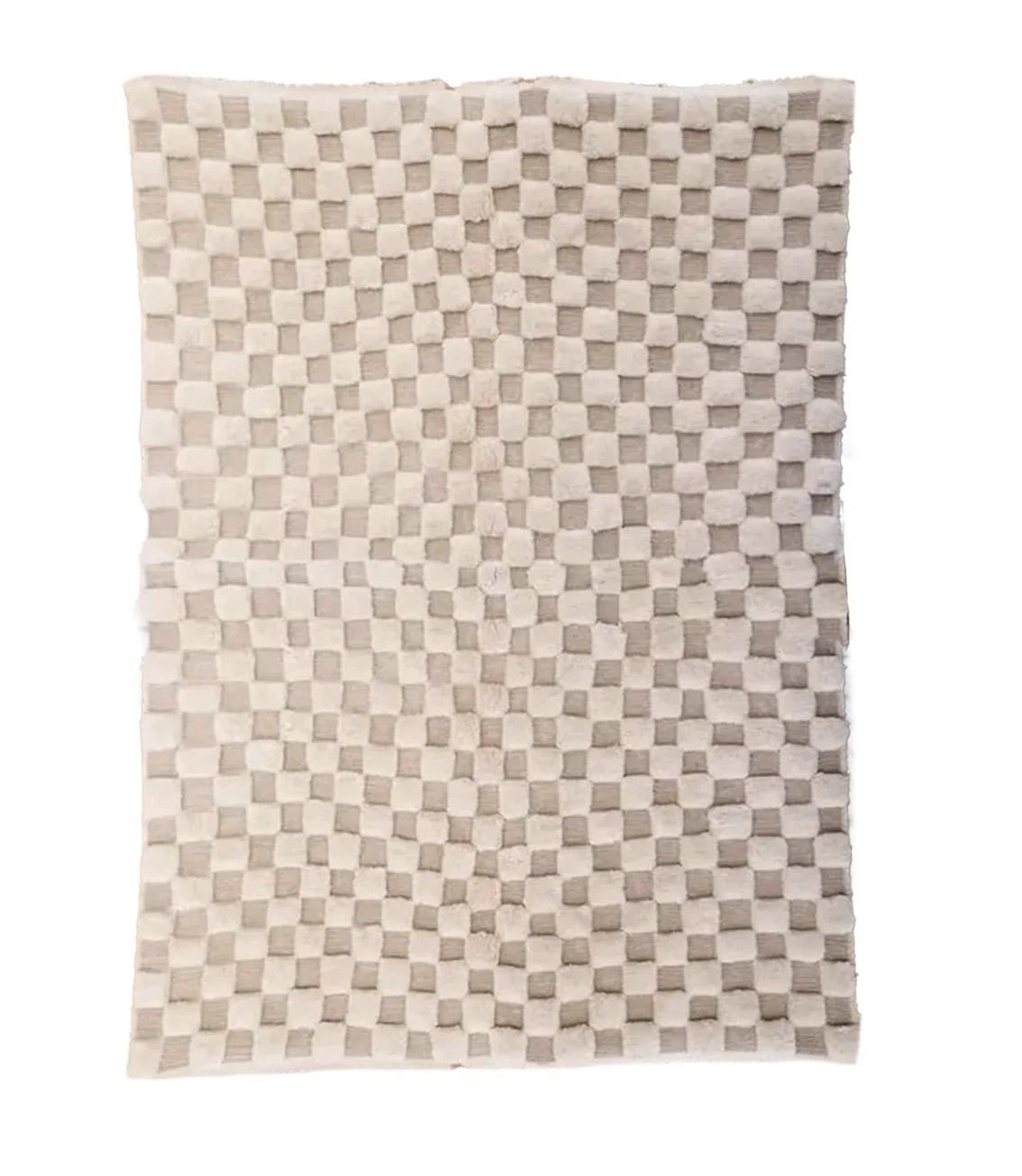Detail close-up of a beige and brown Moroccan rug featuring a geometric pattern.
