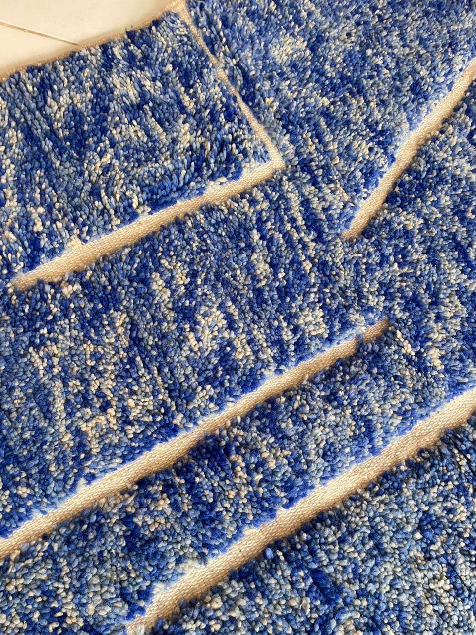 Detail close-up of a blue Moroccan rug showcasing its textured surface and geometric design.