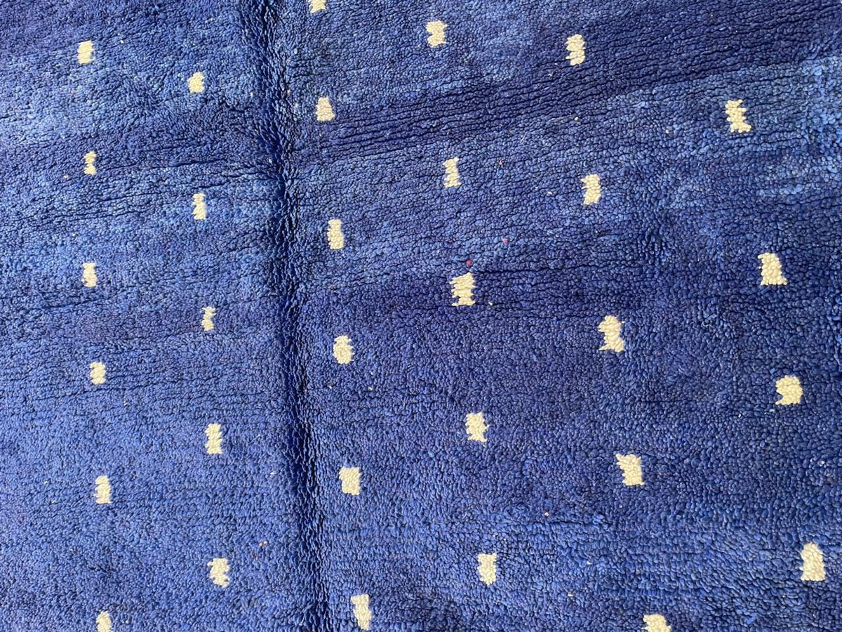 Close-up detail of the soft texture of a blue Moroccan rug.