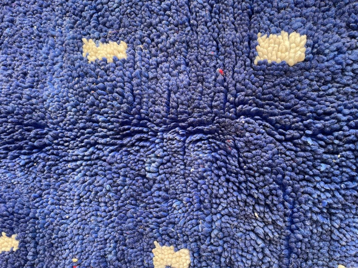 Close-up of the textured pattern on a blue Moroccan rug.