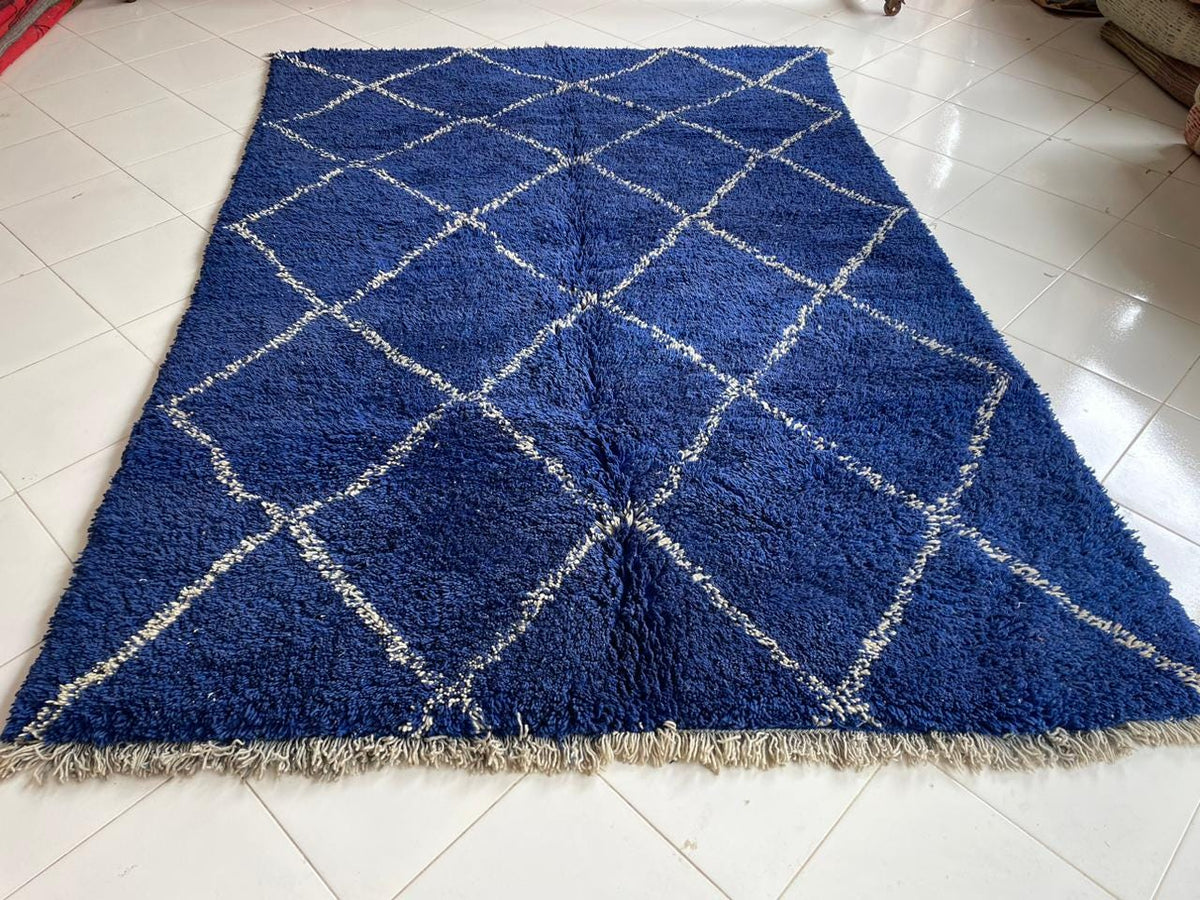 Front view of a blue Moroccan rug featuring a geometric design.