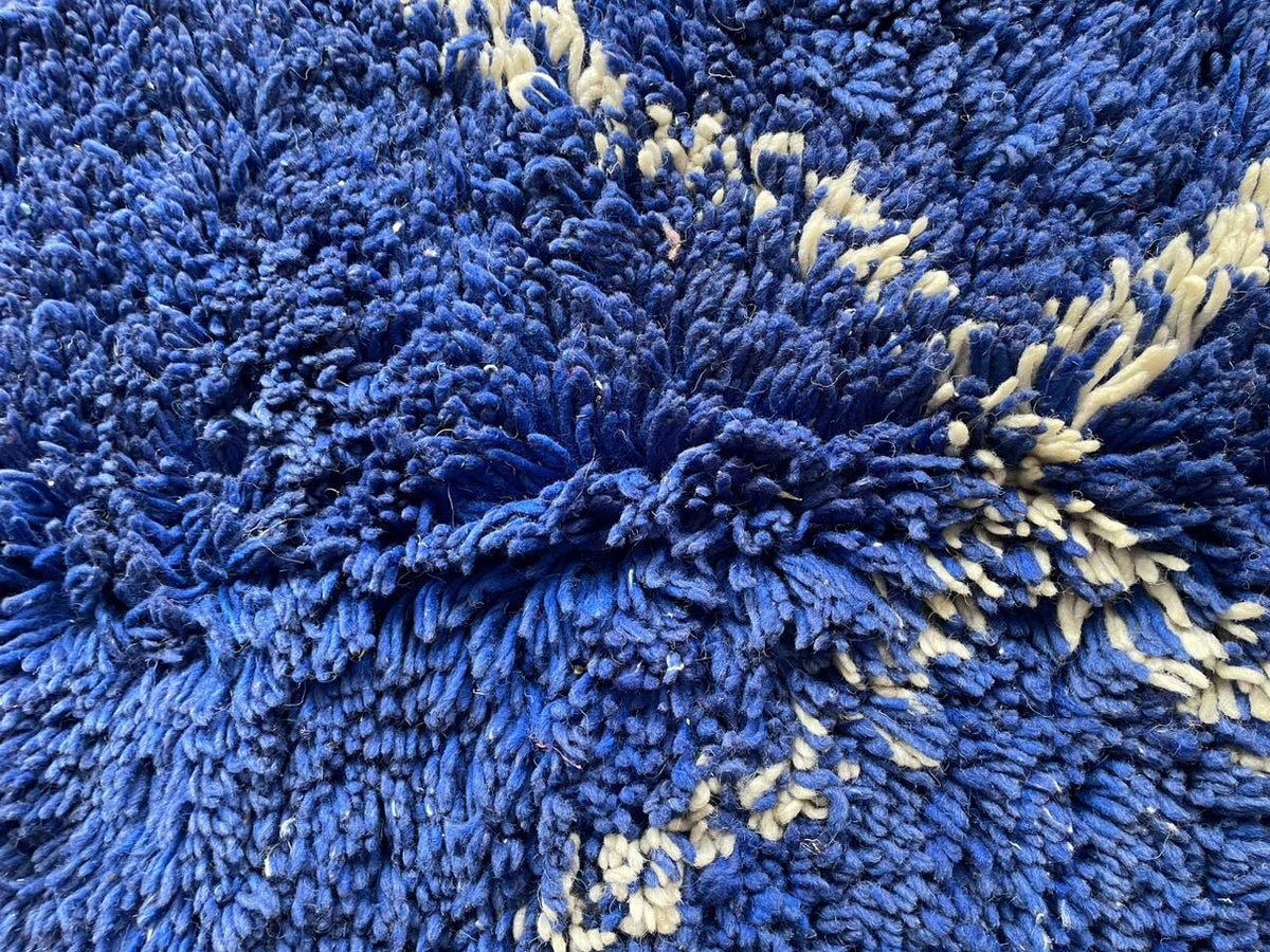Detail close-up of the blue Moroccan rug highlighting its textured surface.