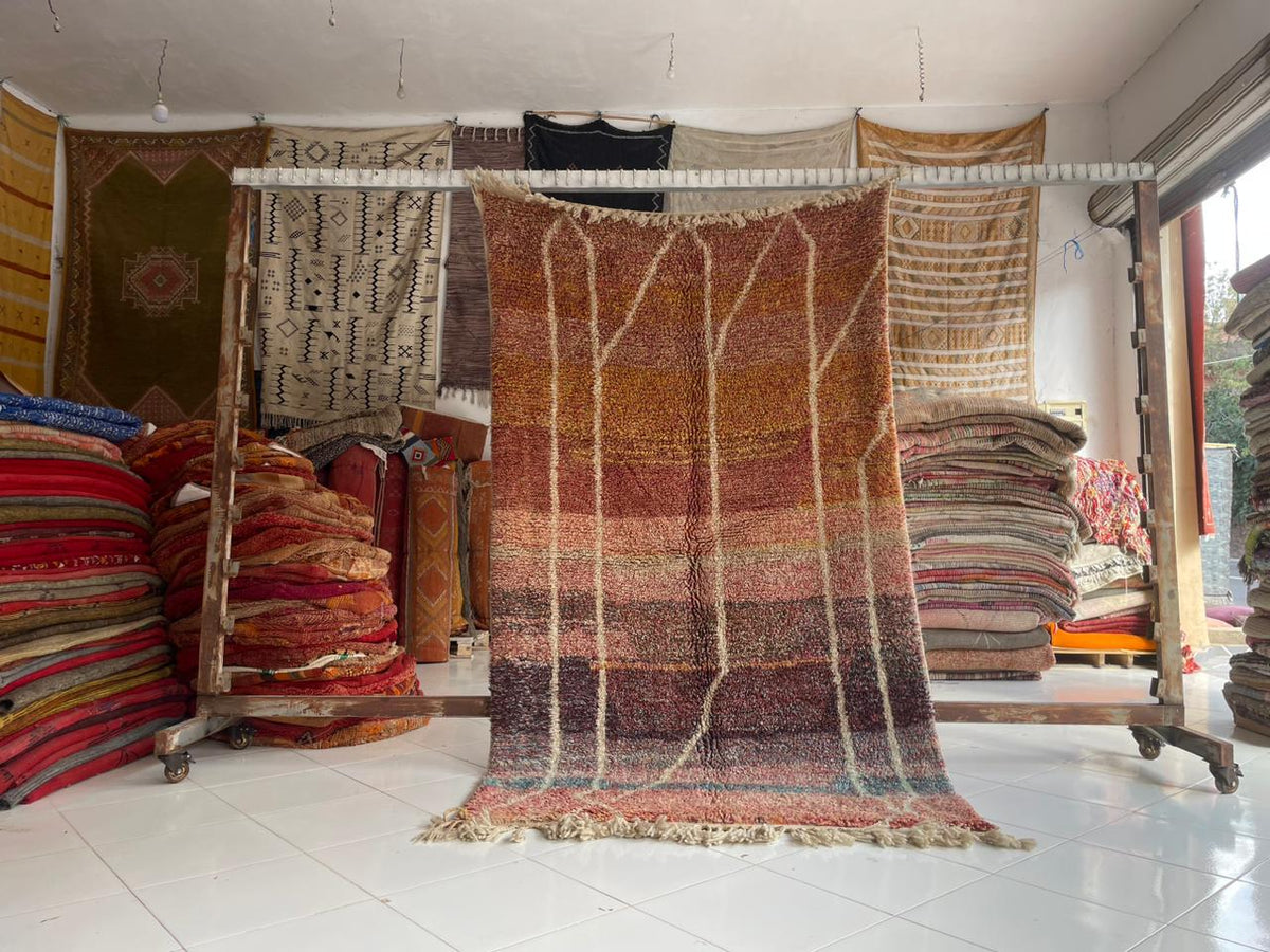 Lifestyle shot of a brown Moroccan rug with a textured surface in a natural setting.