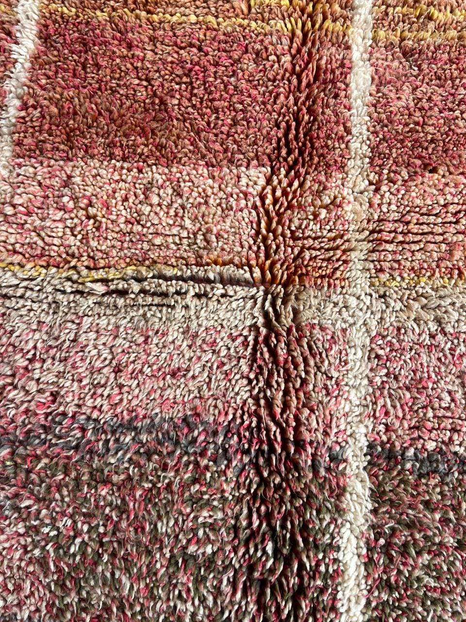 Detail close-up of a brown Moroccan rug with a soft texture and patterned design.