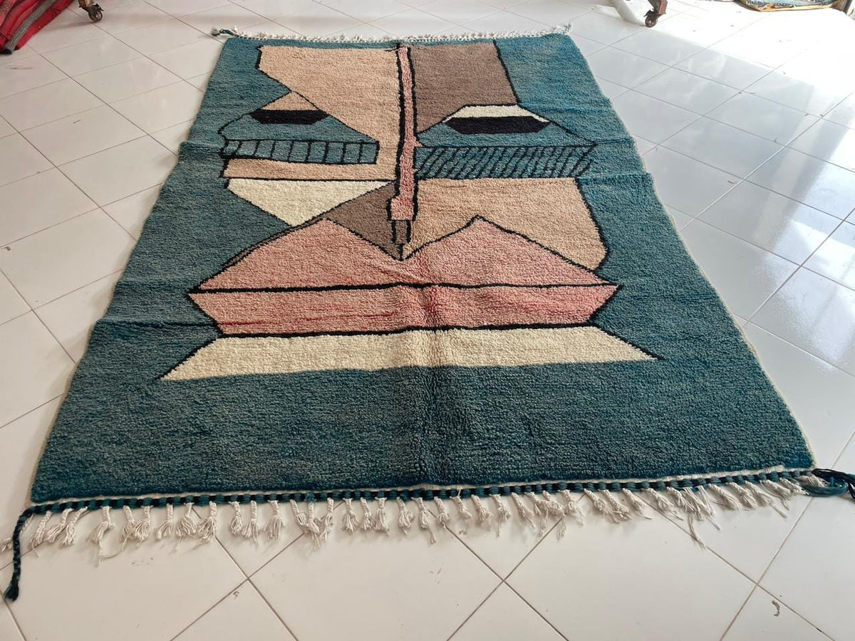 Front view of a colorful Moroccan rug showcasing geometric patterns in blue, brown, and cream.