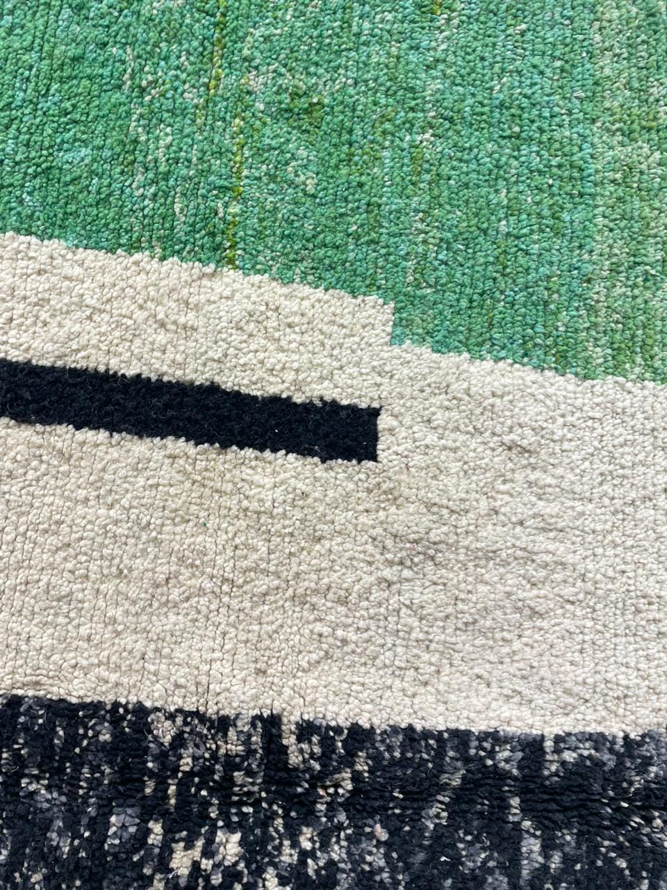 Close-up detail of the textured surface of the colorful Moroccan rug highlighting color blocks.
