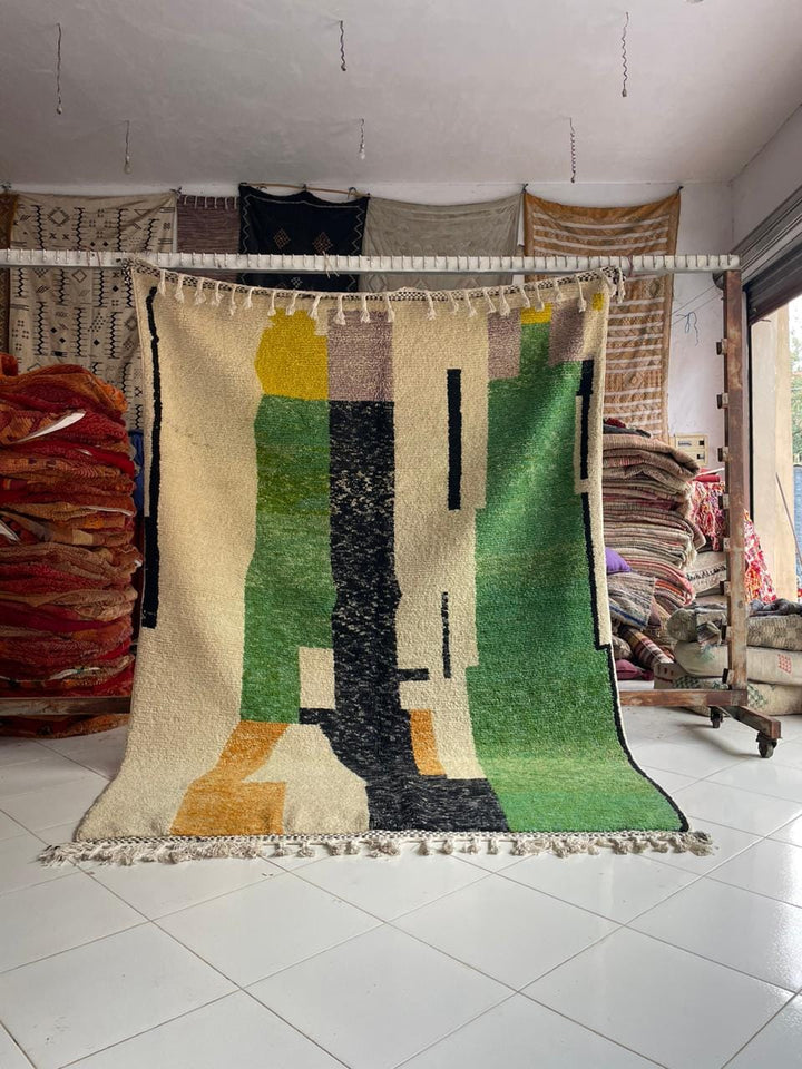 Lifestyle shot of a colorful Moroccan rug featuring abstract design and fringe edges.