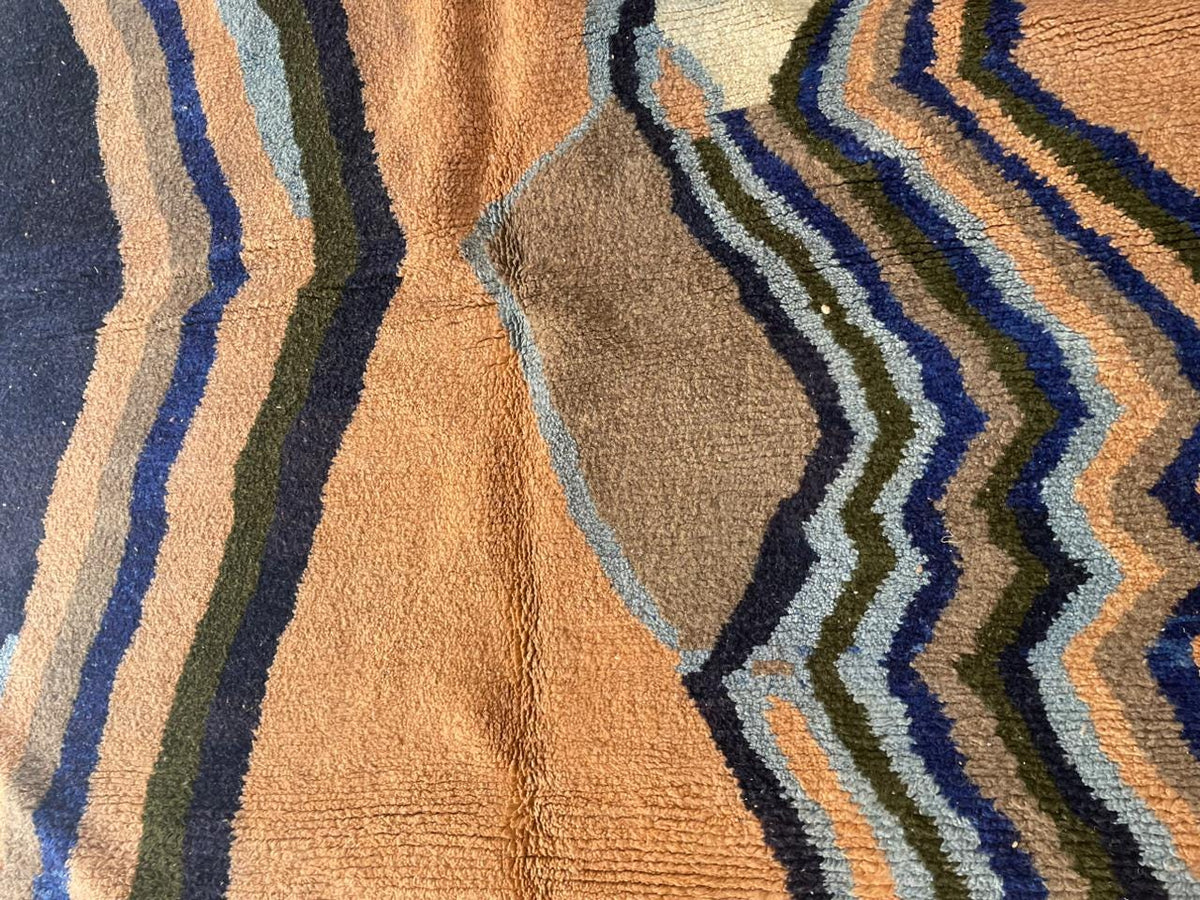 Close-up detail of a colorful Moroccan rug with a textured surface and geometric patterns.