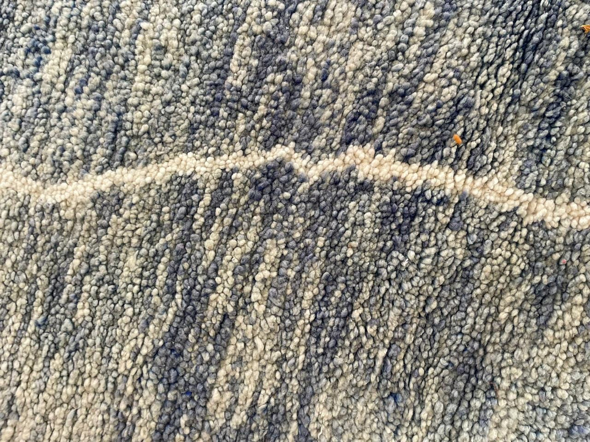 Close-up detail of a textured surface on a gray Moroccan rug.