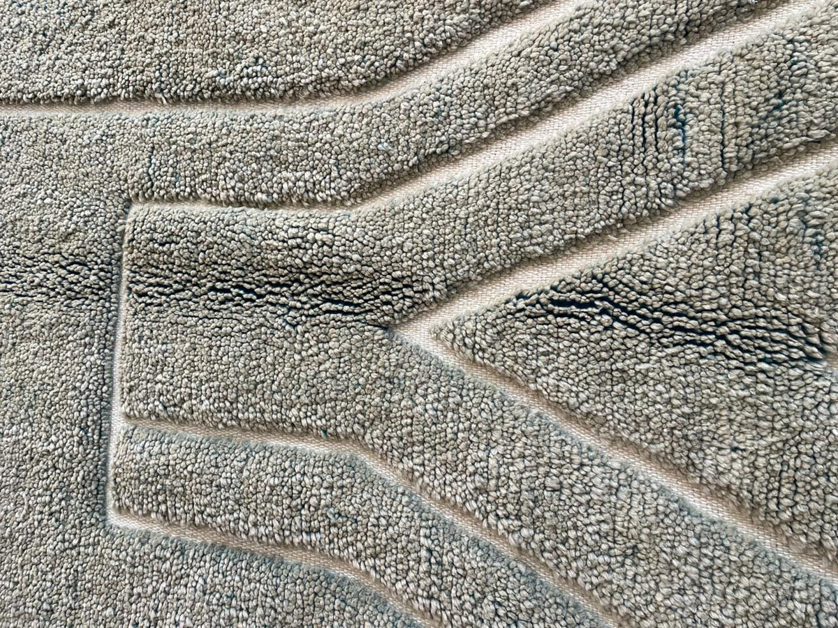 Close-up detail of a gray Moroccan rug highlighting its textured design.