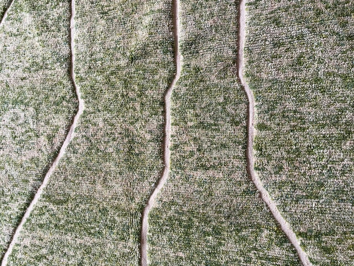 Detail shot of a green Moroccan rug showcasing wavy lines.