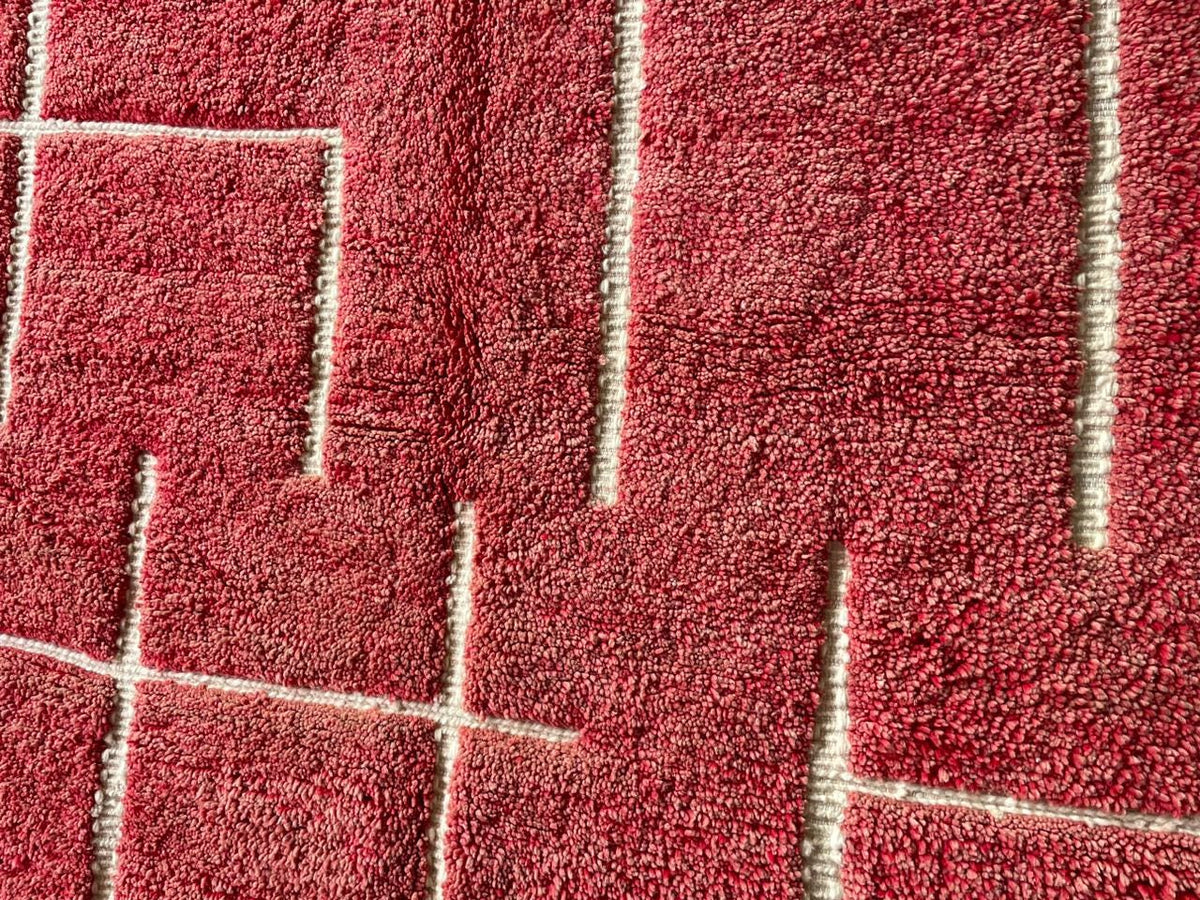 Close-up detail of a red Moroccan rug showcasing its textured pattern.