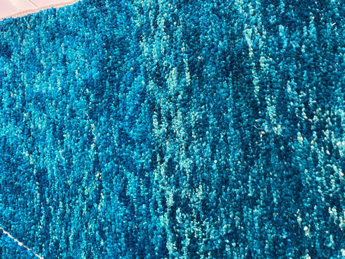 Detail shot of the soft texture of the turquoise Beni Ourain Moroccan rug.
