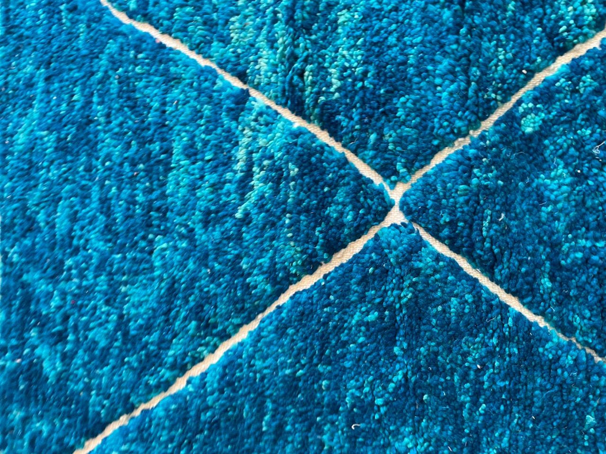 Close-up detail of the textured surface of the turquoise Beni Ourain Moroccan rug.