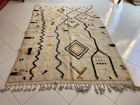 Front view of a white Moroccan rug featuring geometric patterns against a solid background.