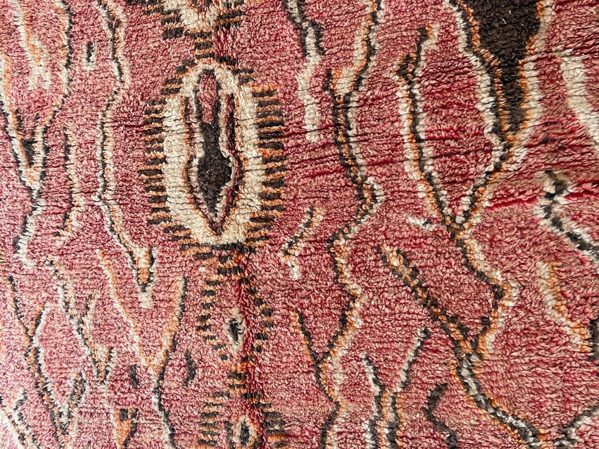 Close-up detail of the woven texture and intricate patterns on a vintage Moroccan rug.
