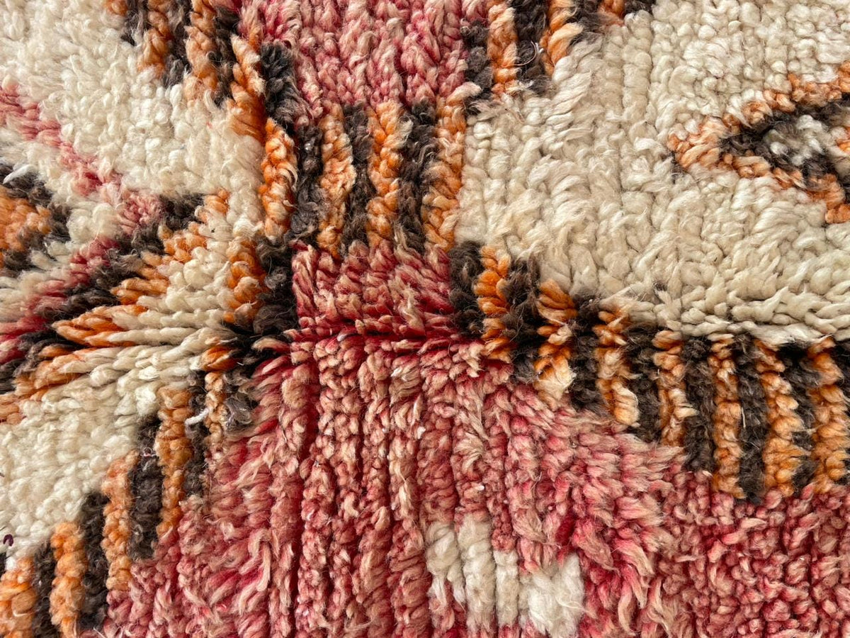 Detail shot highlighting the textured design and color contrast of a vintage Moroccan rug.