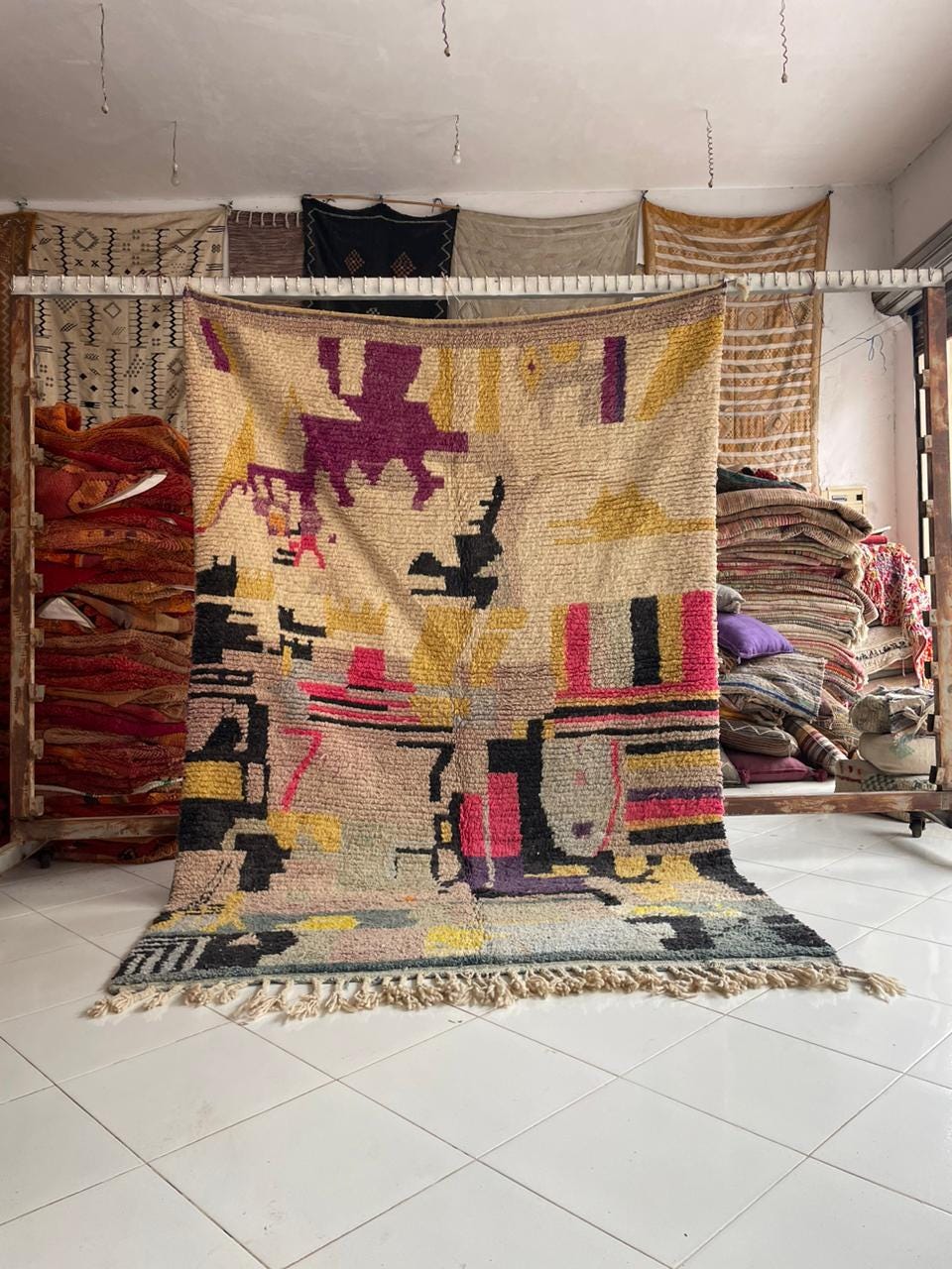 Lifestyle shot of a colorful Moroccan rug with geometric patterns on a natural background.