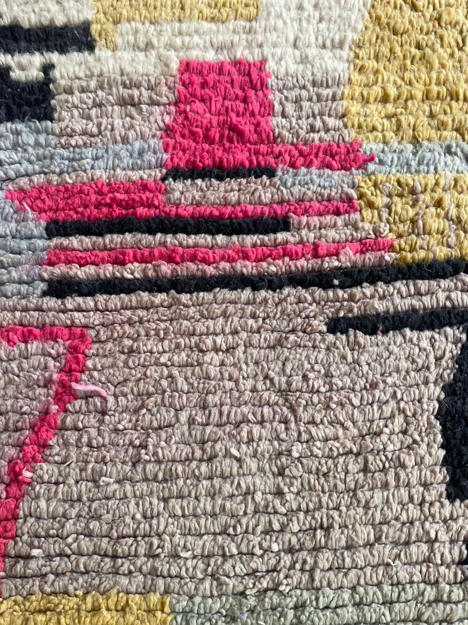 Close-up of a colorful rug showcasing a textured pattern in red, black, and yellow.