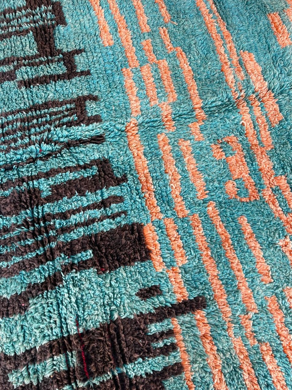 Close-up detail showcasing abstract patterns and textured fibers in blue, orange, and black.