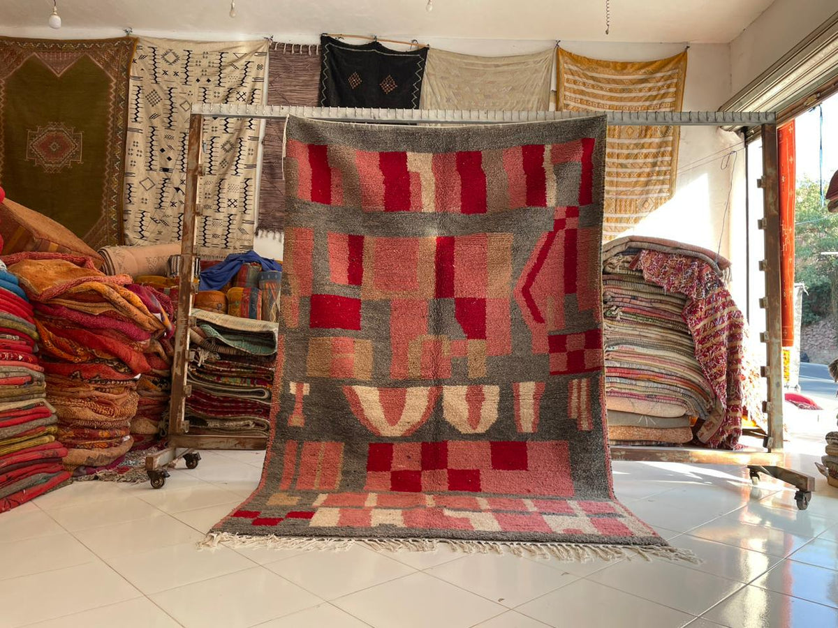 Lifestyle shot displaying the pink vintage Moroccan rug with various patterns in a natural setting.