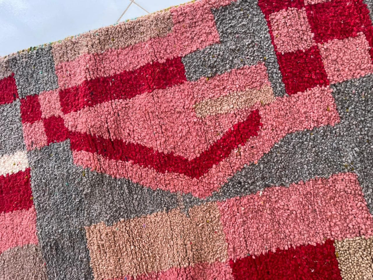 Close-up detail of abstract patterns on the pink vintage Moroccan rug.