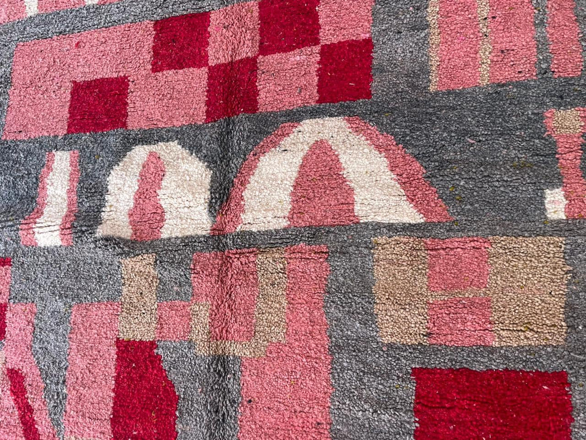 Close-up detail of geometric shapes on the pink vintage Moroccan rug.
